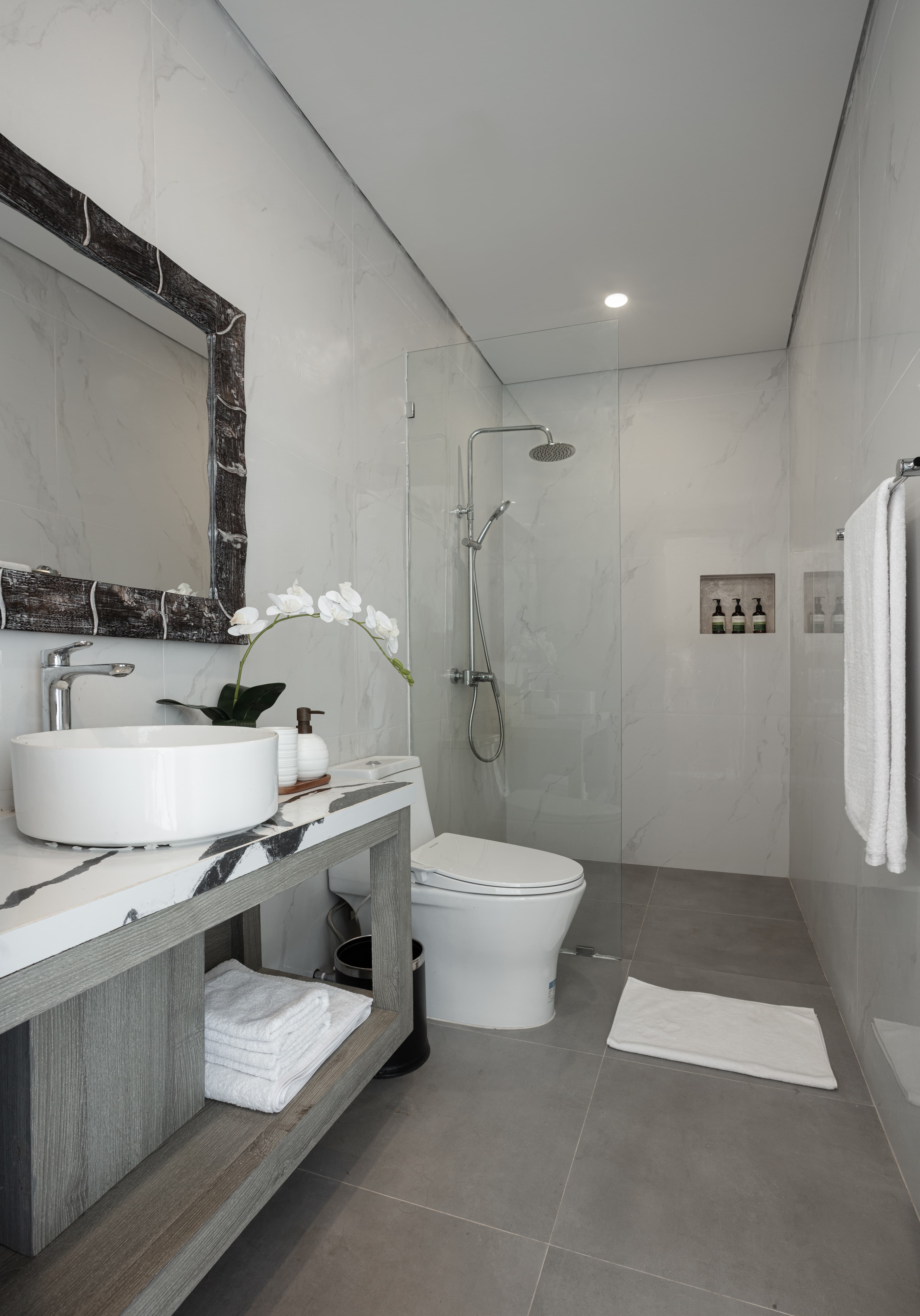 Close-up of high-end tactile bathroom amenities on a raw marble vanity